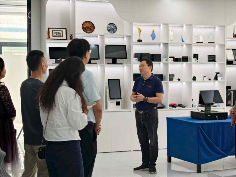 OCOM executive introducing POS hardware products to suppliers in the new headquarters showroom