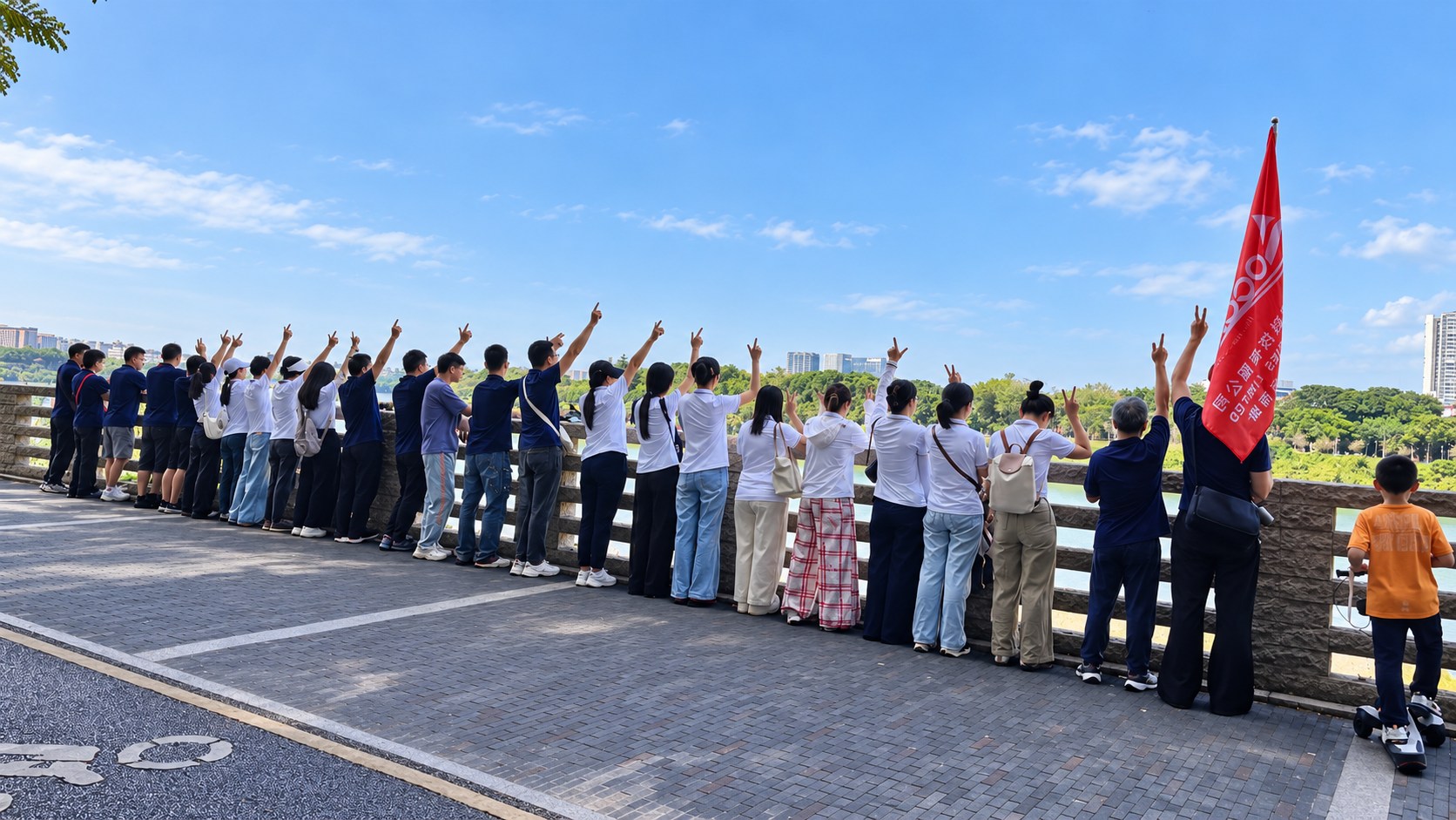 The OCOM team gathers along the Lixin Lake railing, raising their hands beside the company flag.